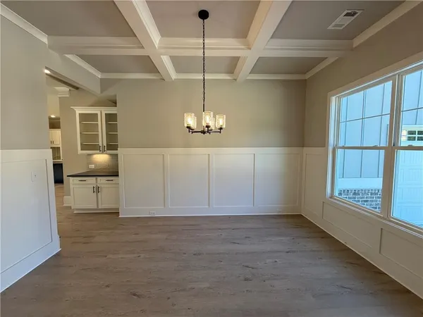 a view of an empty room with window and cabinet