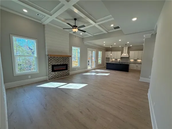 a view of an empty room with a fireplace and a window