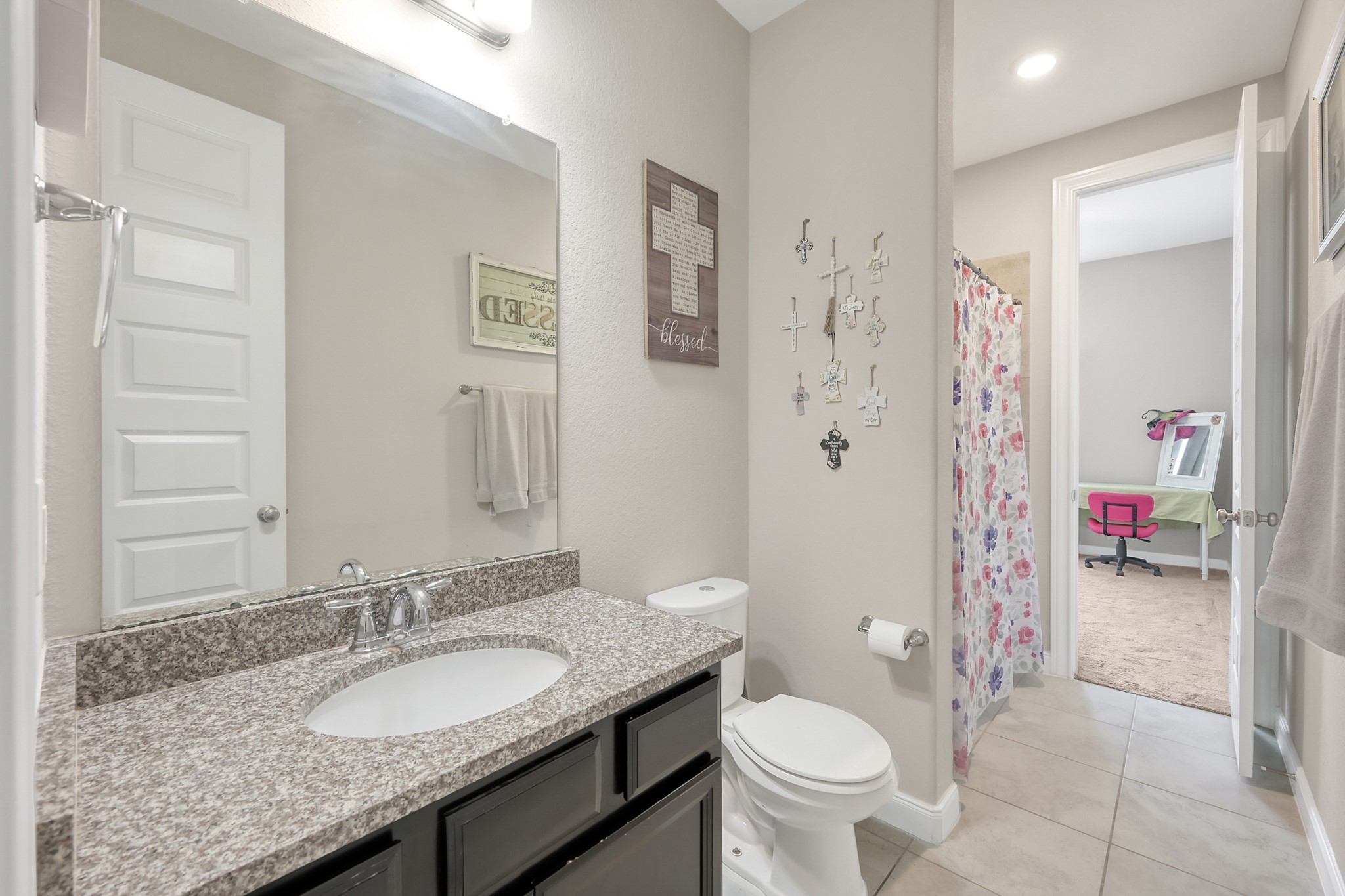 17923 Durango Point Court Tomball, TX 77377 - Photo 28 of 36 There is a private entrance from the front room to secondary bathroom. The secondary bedroom has a granite counter with undermount sink and tile flooring. There is a tub/shower combo in this bathroom.