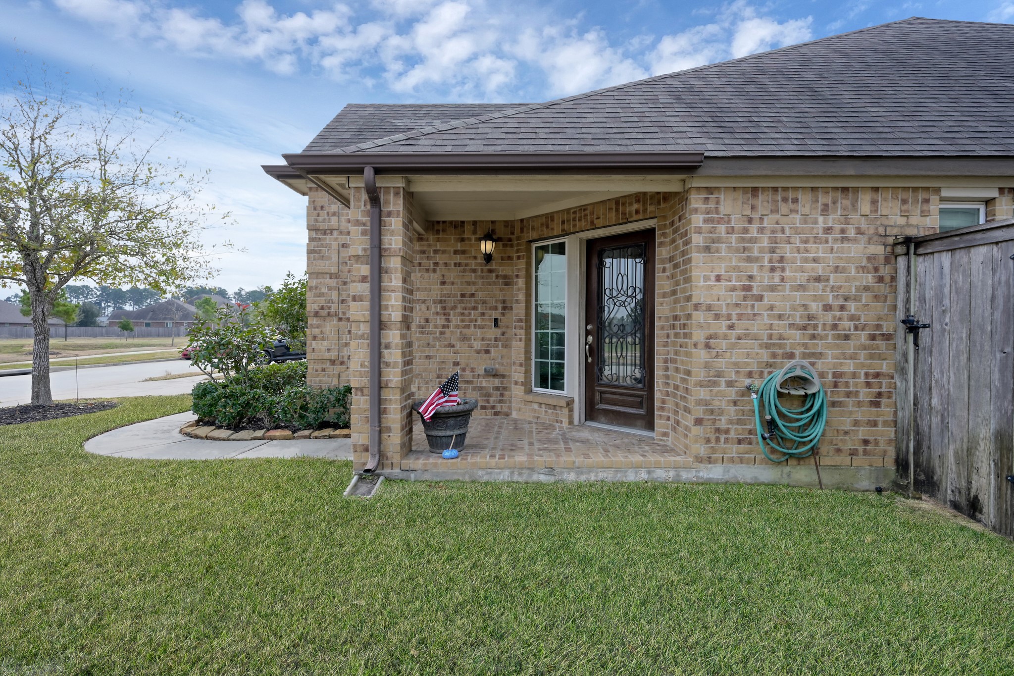 17923 Durango Point Court Tomball, TX 77377 - Photo 3 of 36 The covered front porch has brick pavers and a wrought iron wood door.