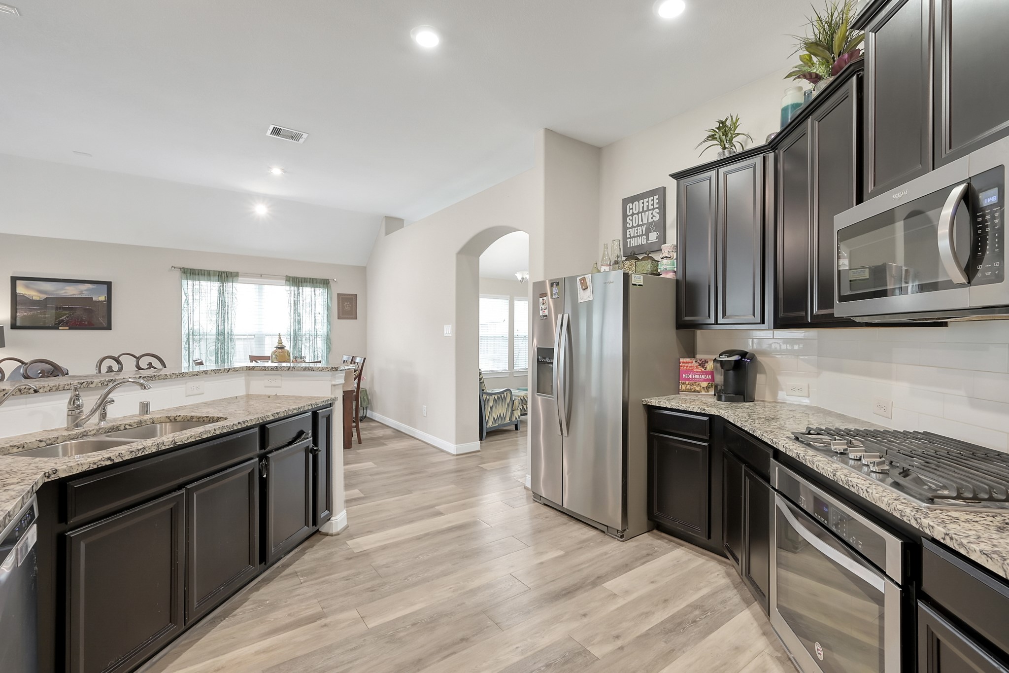 17923 Durango Point Court Tomball, TX 77377 - Photo 8 of 36 As you proceed into the family gathering area it opens up to the kitchen, breakfast and family room. The LVP and high ceilings continue in this area of the home.