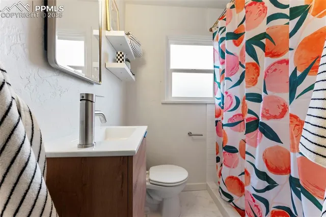 a bathroom with a sink and mirror with toilet