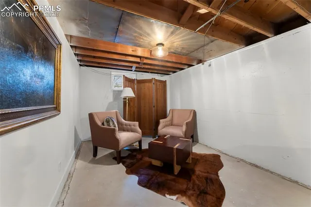 a couple of blue chairs sitting in a room next to a window