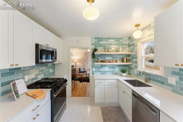 a kitchen that has a sink and a stove in it