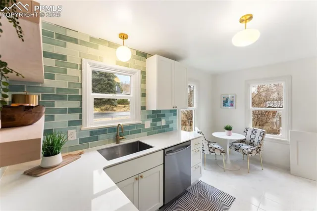 a kitchen with a stove a sink and a refrigerator