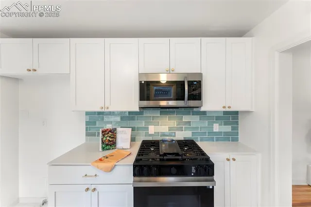 a kitchen with a stove and a microwave