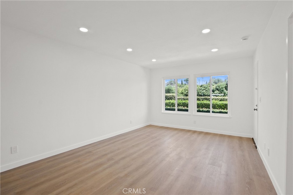 4635 Beach Boulevard Buena Park, CA 90621 - Photo 18 of 32 a view of an empty room with wooden floor and a window