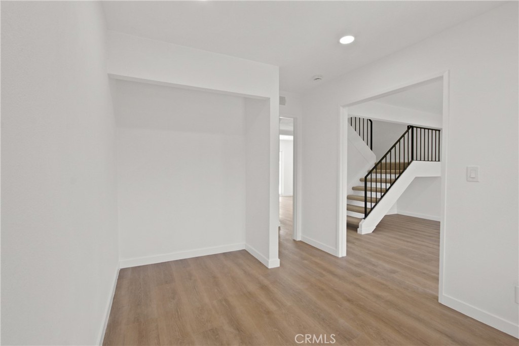 4635 Beach Boulevard Buena Park, CA 90621 - Photo 20 of 32 a view of an empty room with wooden floor and stairs