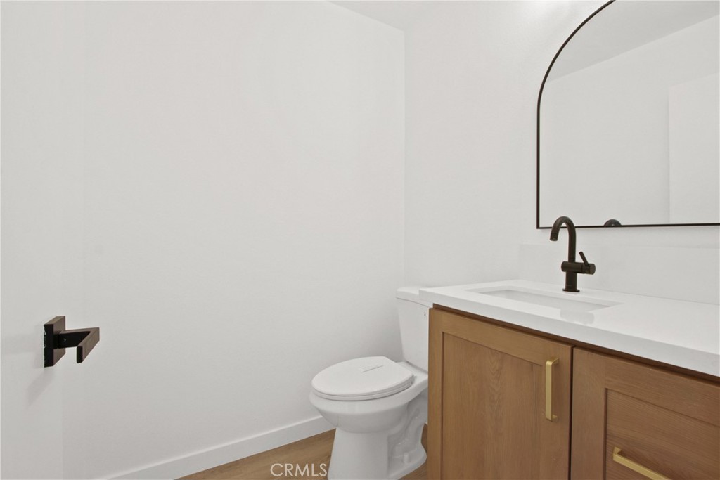 4635 Beach Boulevard Buena Park, CA 90621 - Photo 21 of 32 a bathroom with a granite countertop toilet and a sink