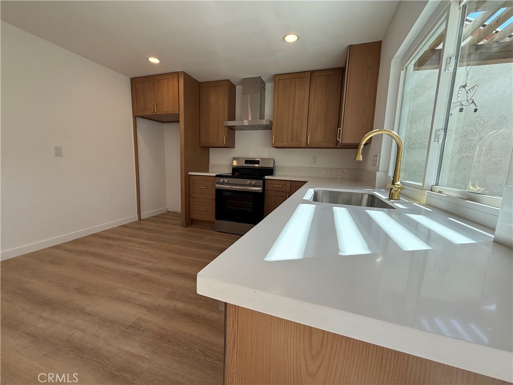 4635 Beach Boulevard Buena Park, CA 90621 - Photo 32 of 32 a kitchen with granite countertop a sink a stove and a refrigerator