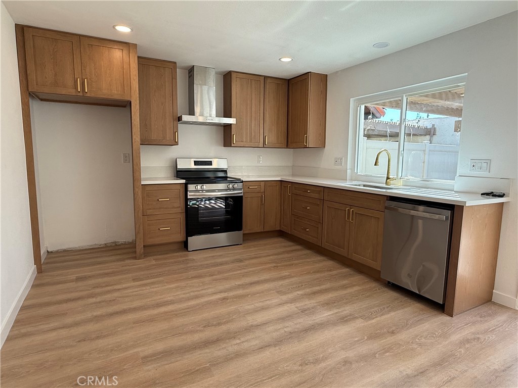 4635 Beach Boulevard Buena Park, CA 90621 - Photo 4 of 32 a kitchen with stainless steel appliances granite countertop a stove a sink dishwasher and a refrigerator