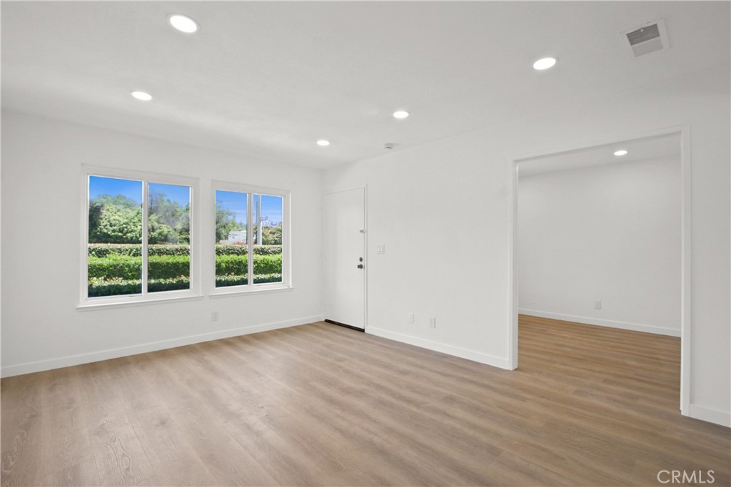 4635 Beach Boulevard Buena Park, CA 90621 - Photo 5 of 32 an empty room with wooden floor and windows