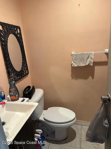 a bathroom with a toilet and a mirror