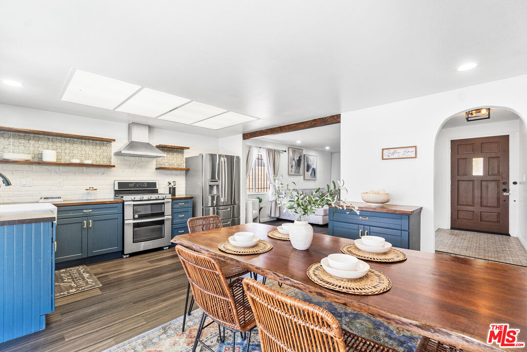 24613 Neptune Avenue Carson, CA 90745 - Photo 12 of 33 a kitchen with stainless steel appliances kitchen island granite countertop a dining table and chairs