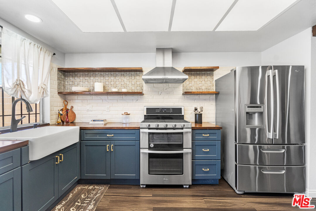 24613 Neptune Avenue Carson, CA 90745 - Photo 14 of 33 a kitchen with stainless steel appliances granite countertop a stove and a refrigerator