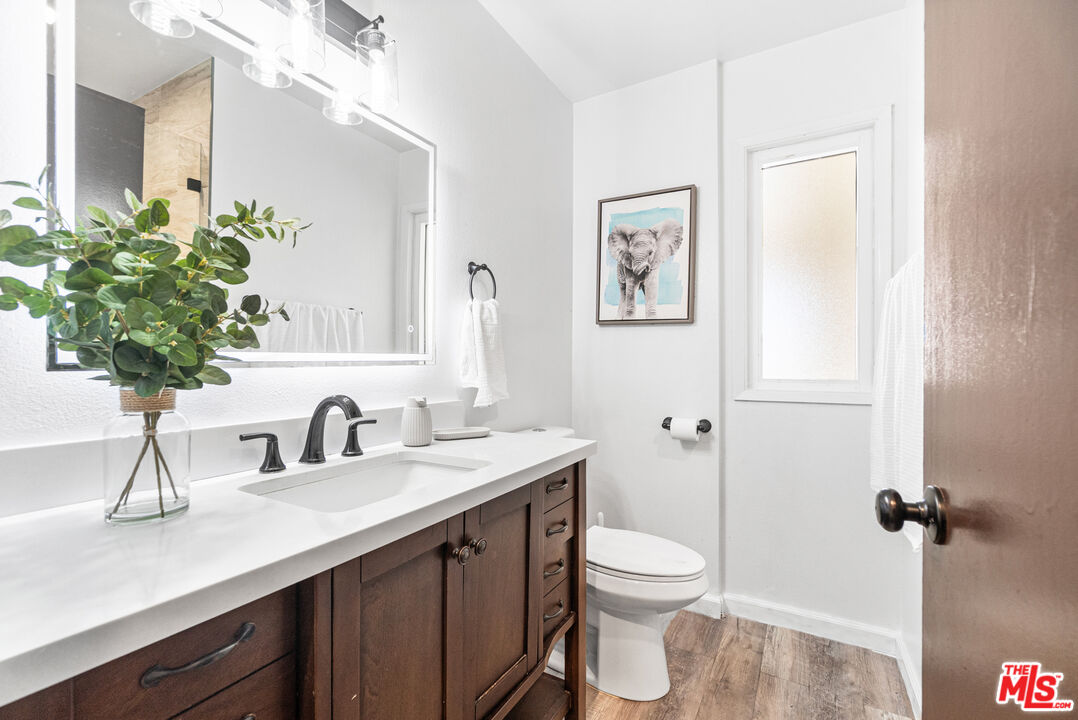 24613 Neptune Avenue Carson, CA 90745 - Photo 15 of 33 a bathroom with a toilet a sink and mirror
