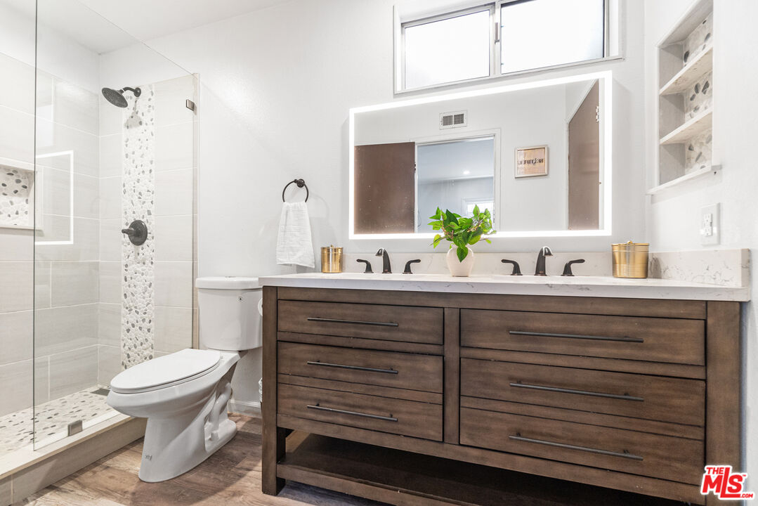 24613 Neptune Avenue Carson, CA 90745 - Photo 21 of 33 a bathroom with a sink a toilet and shower