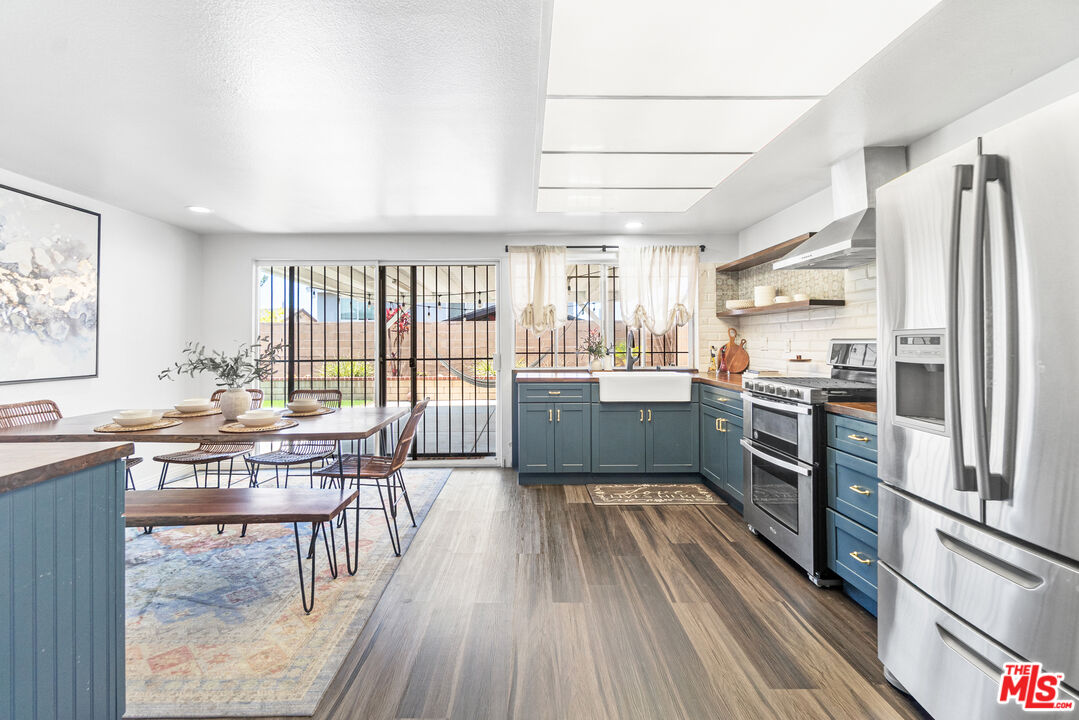 24613 Neptune Avenue Carson, CA 90745 - Photo 8 of 33 a kitchen with stainless steel appliances a lot of counter space and a wooden floors