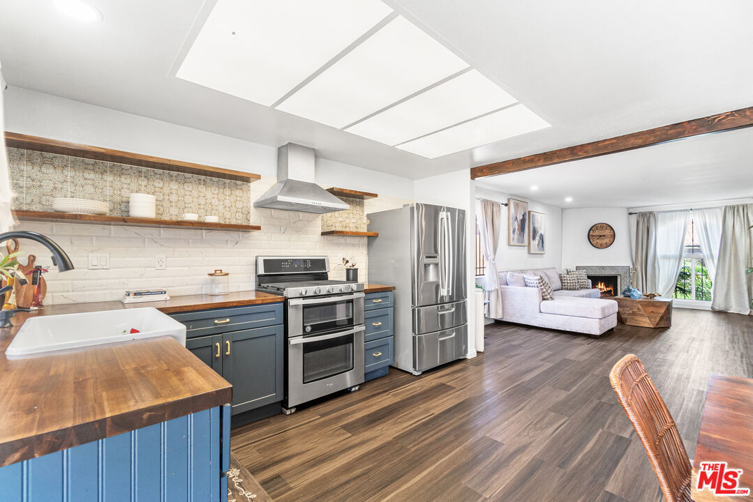 24613 Neptune Avenue Carson, CA 90745 - Photo 10 of 33 a kitchen view with wooden floor and stainless steel appliances