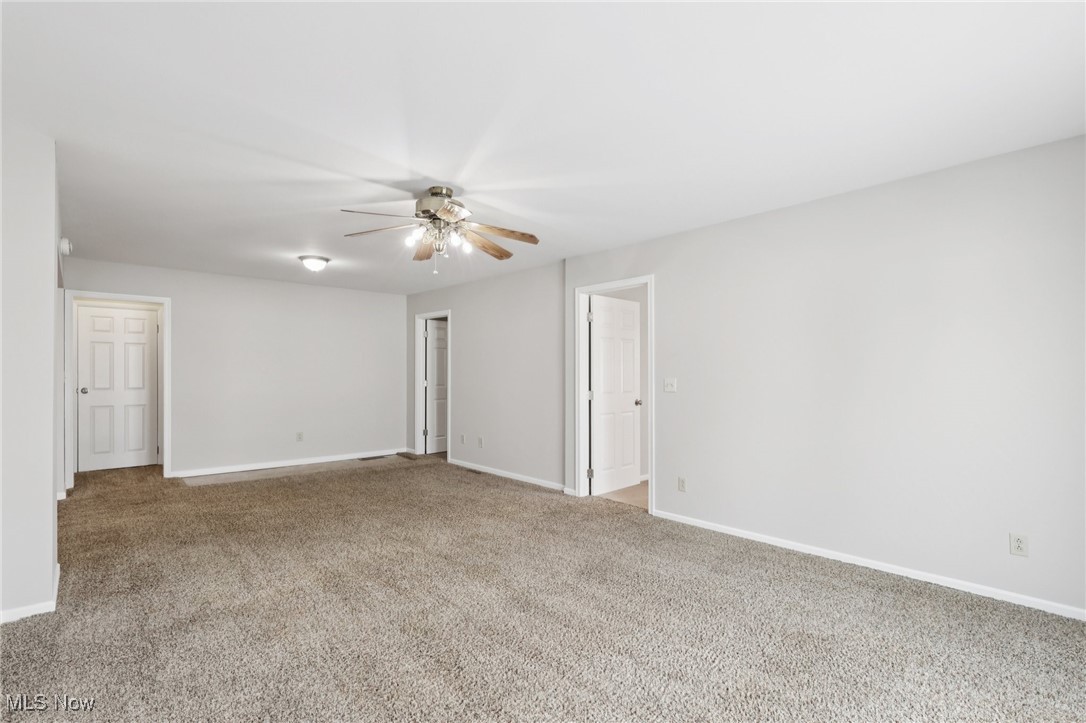 611 Wilson Street Struthers, OH 44471 - Photo 16 of 44 Empty room with light colored carpet and a ceiling fan