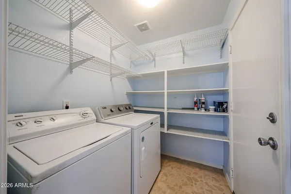 a view of storage and utility room with washer and dryer