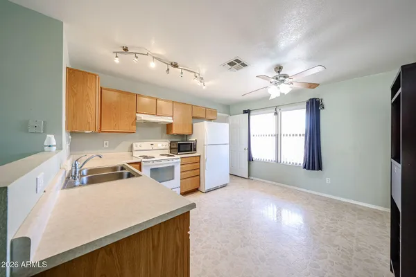 a kitchen that has a lot of cabinets and wooden floor