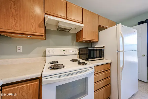 a kitchen with stainless steel appliances granite countertop a refrigerator and a stove