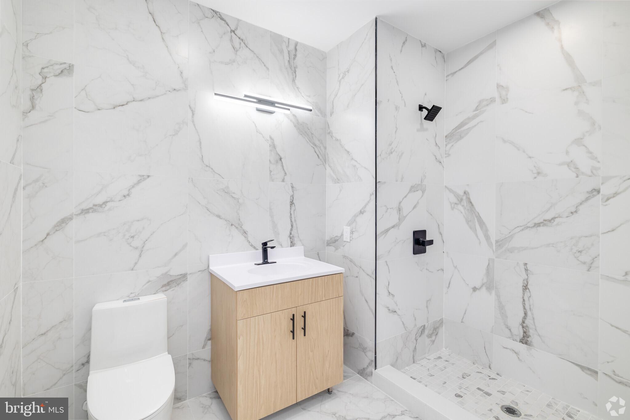 1222 North 2nd Street, Unit 403 Philadelphia, PA 19122 - Photo 16 of 37 a bathroom with a sink toilet and shower