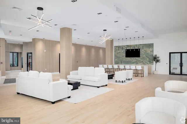 a living room with furniture and a chandelier