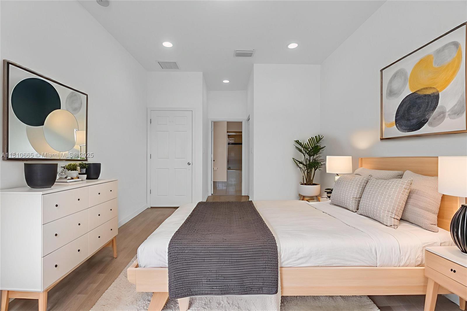 11014 Southwest 237th Lane Homestead, FL 33032 - Photo 4 of 47 a bedroom with a bed and cabinets