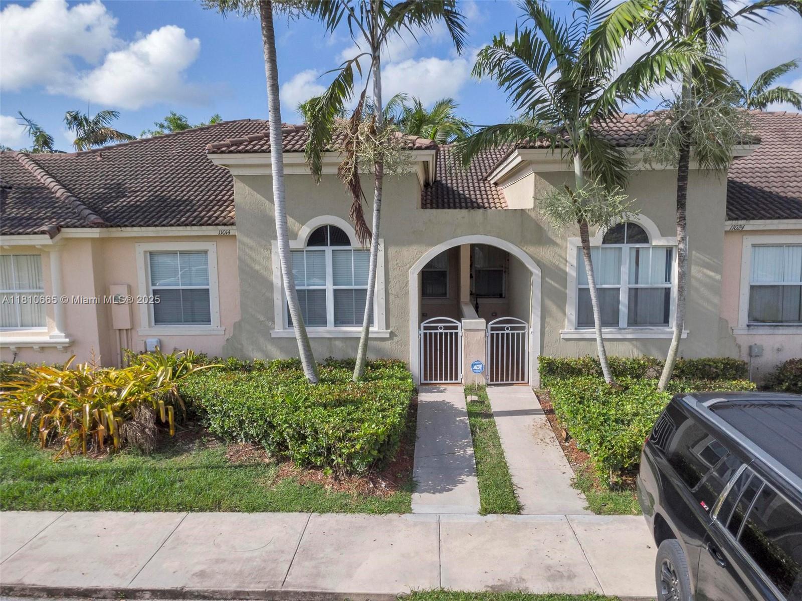 11014 Southwest 237th Lane Homestead, FL 33032 - Photo 9 of 47 a front view of a house with a garden