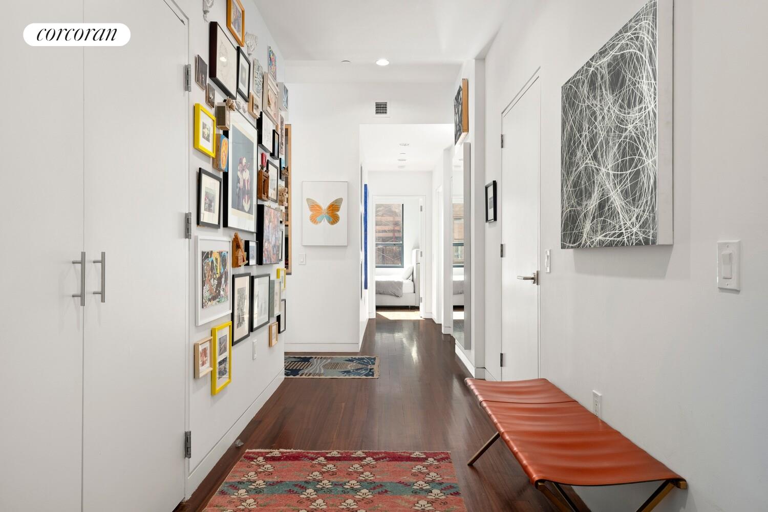 52 Thomas Street, Unit 3D Manhattan, NY 10013 - Photo 11 of 13 a hallway with wooden floor windows and a livingroom