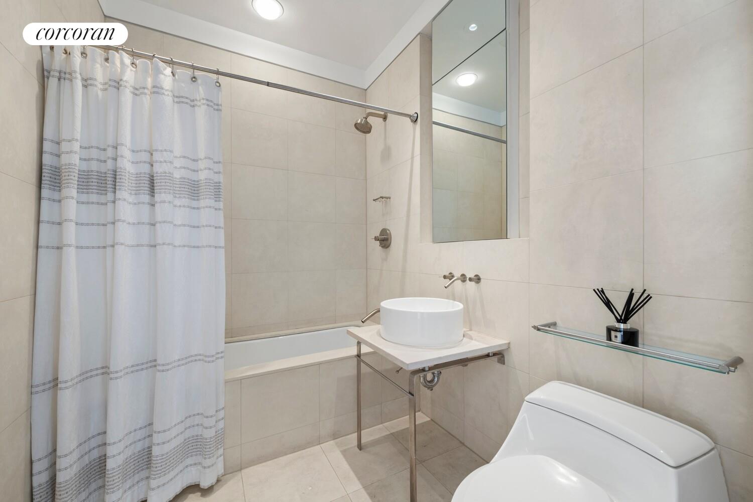 52 Thomas Street, Unit 3D Manhattan, NY 10013 - Photo 12 of 13 a bathroom with a sink toilet and shower