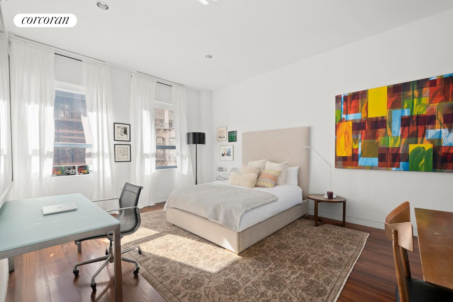 52 Thomas Street, Unit 3D Manhattan, NY 10013 - Photo 6 of 13 a bedroom with a bed and wooden floor