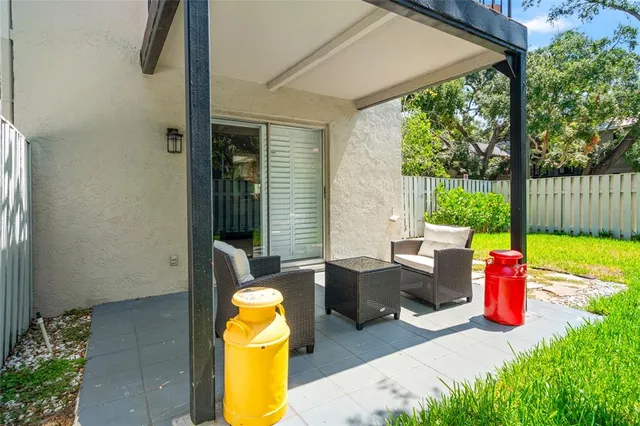 a backyard of a house with table and chairs