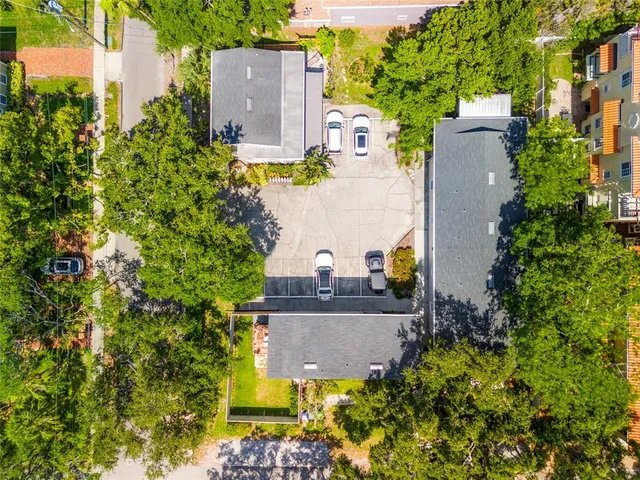 an aerial view of a house with a yard and garden