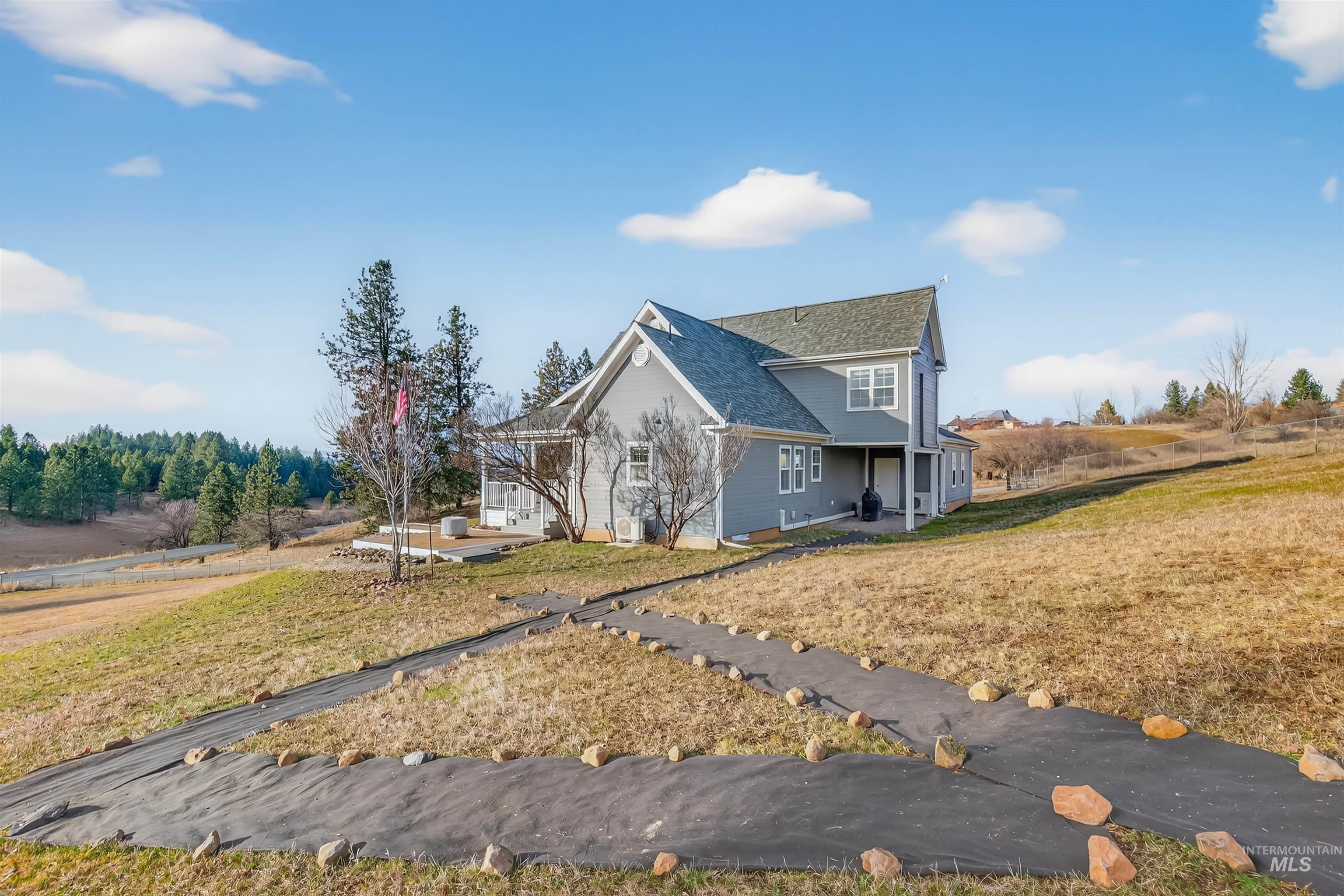 108 Tweedy Lane Kooskia, ID 83539 - Photo 11 of 48 View of side of property with a lawn and roof with shingles