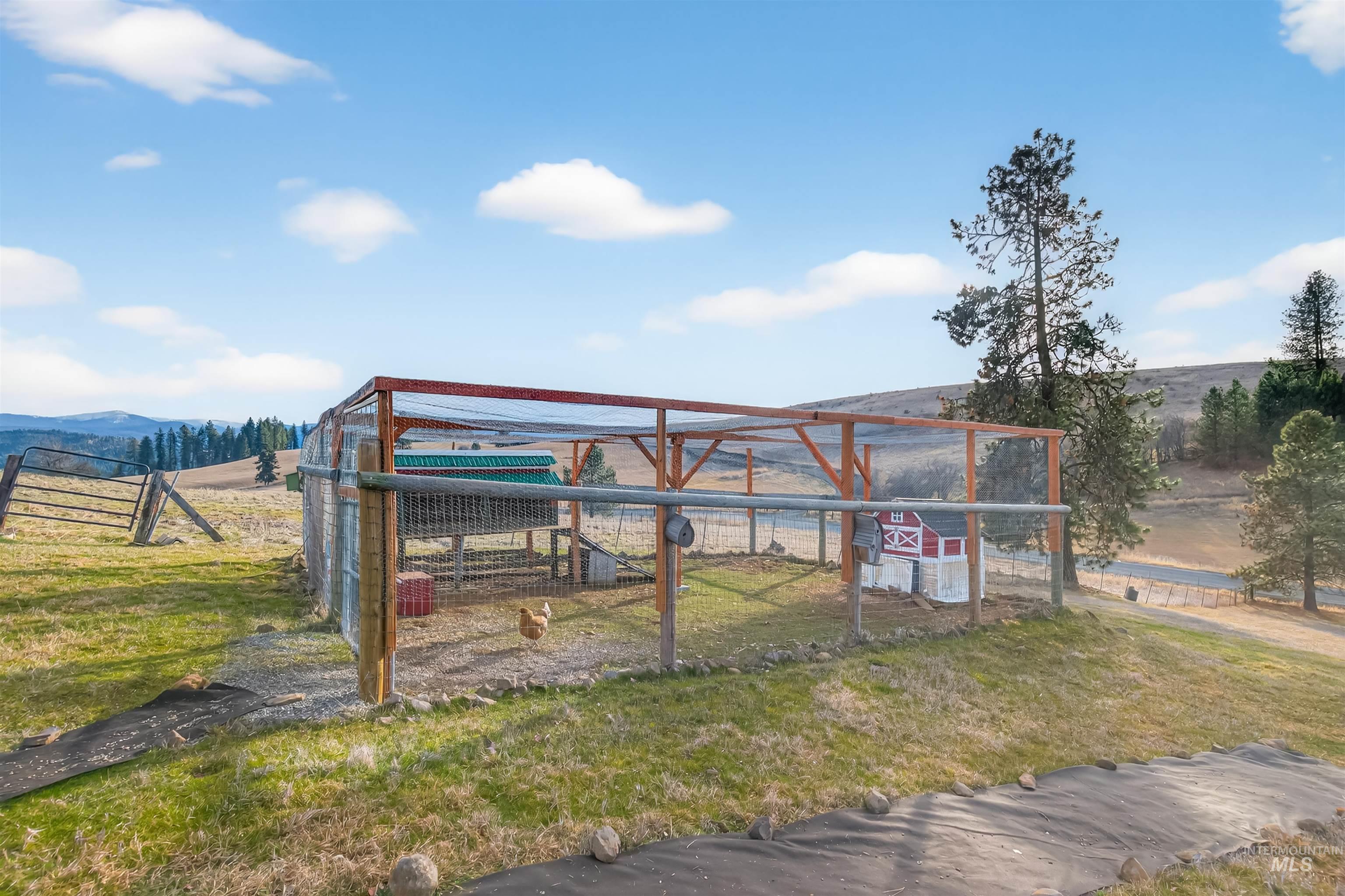 108 Tweedy Lane Kooskia, ID 83539 - Photo 14 of 48 Gate featuring a view of rural / pastoral area, a lawn, and an outbuilding