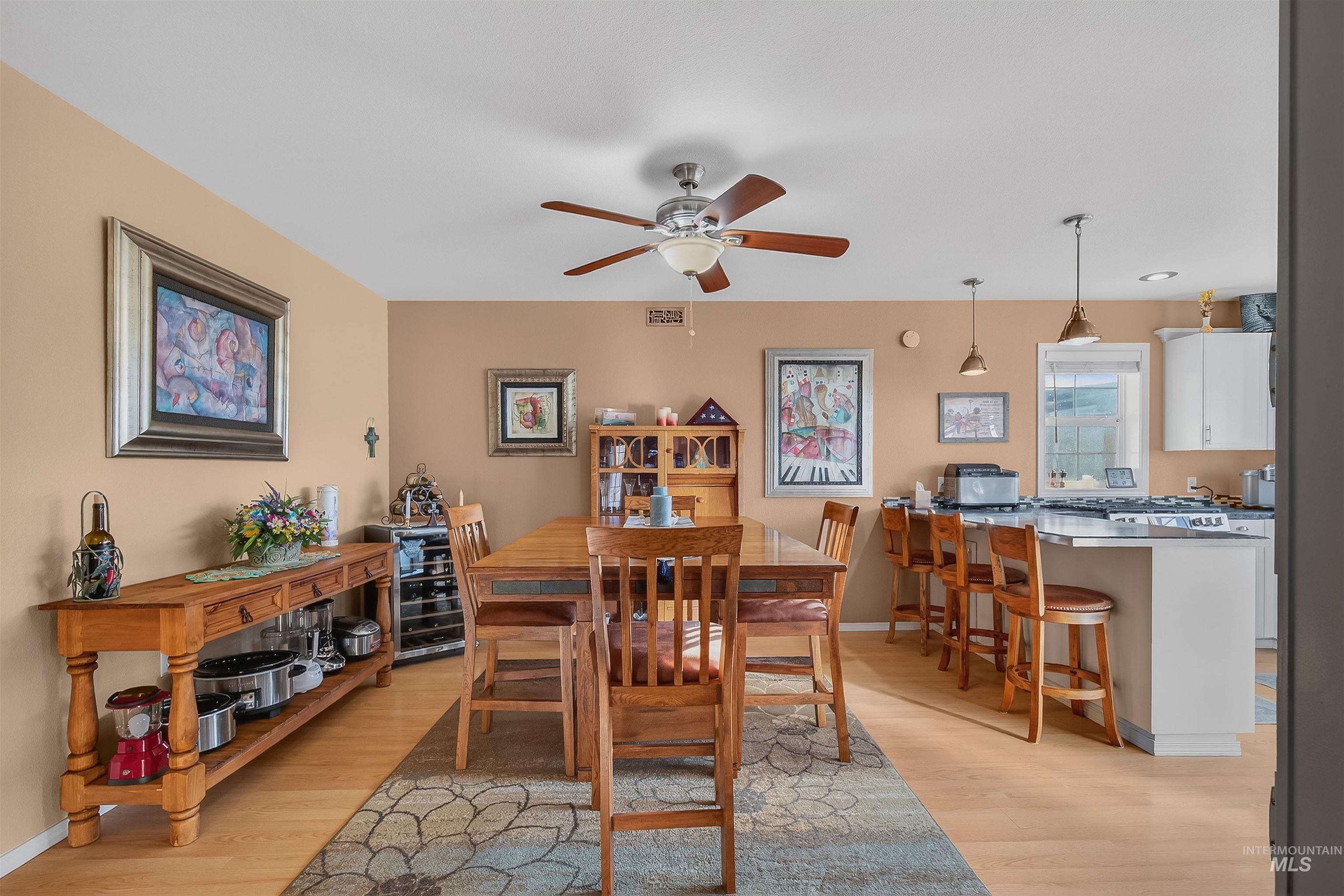 108 Tweedy Lane Kooskia, ID 83539 - Photo 22 of 48 Dining space with light wood finished floors, ceiling fan, and wine cooler