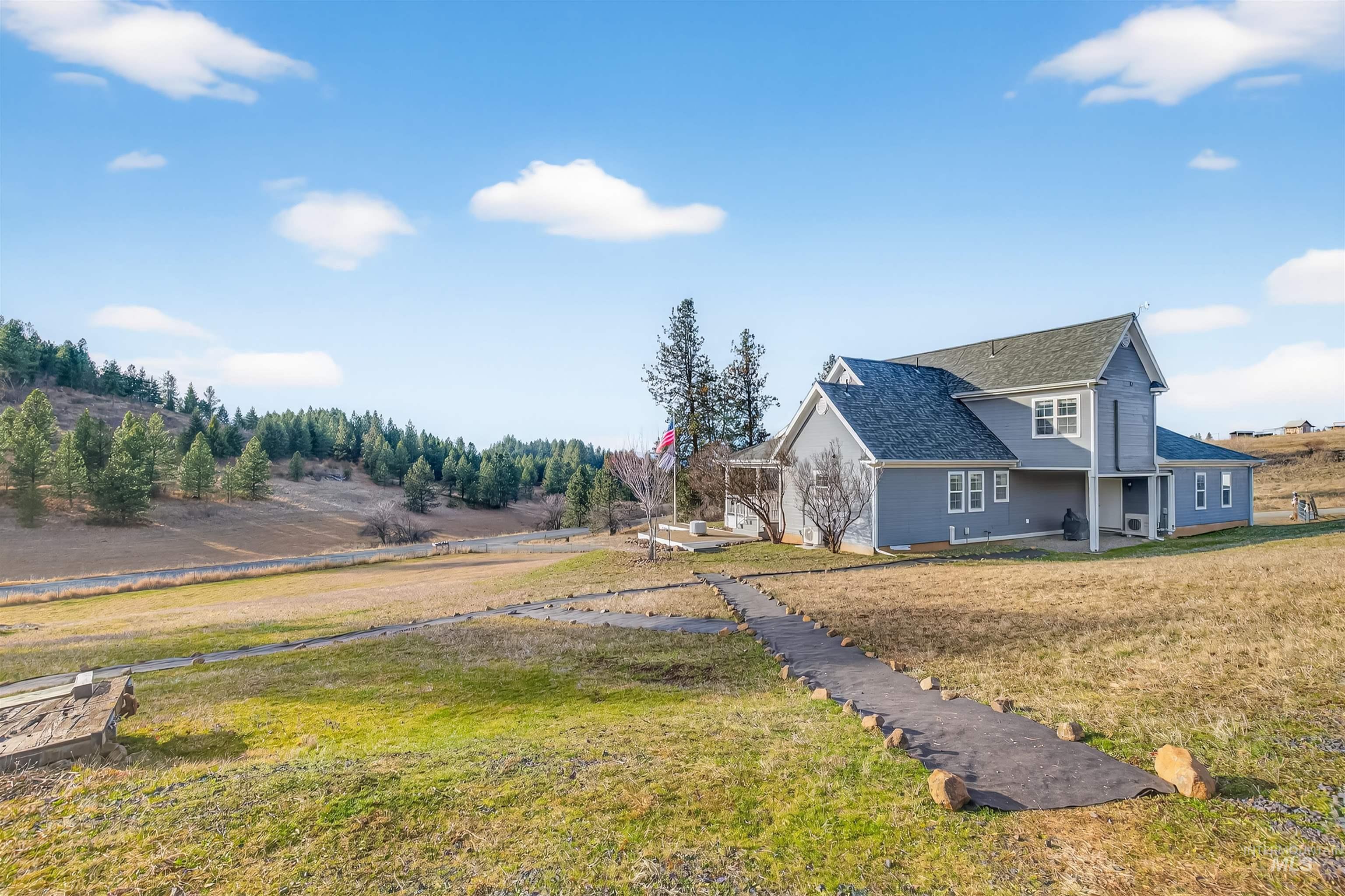 108 Tweedy Lane Kooskia, ID 83539 - Photo 3 of 48 View of side of home with a yard and a shingled roof
