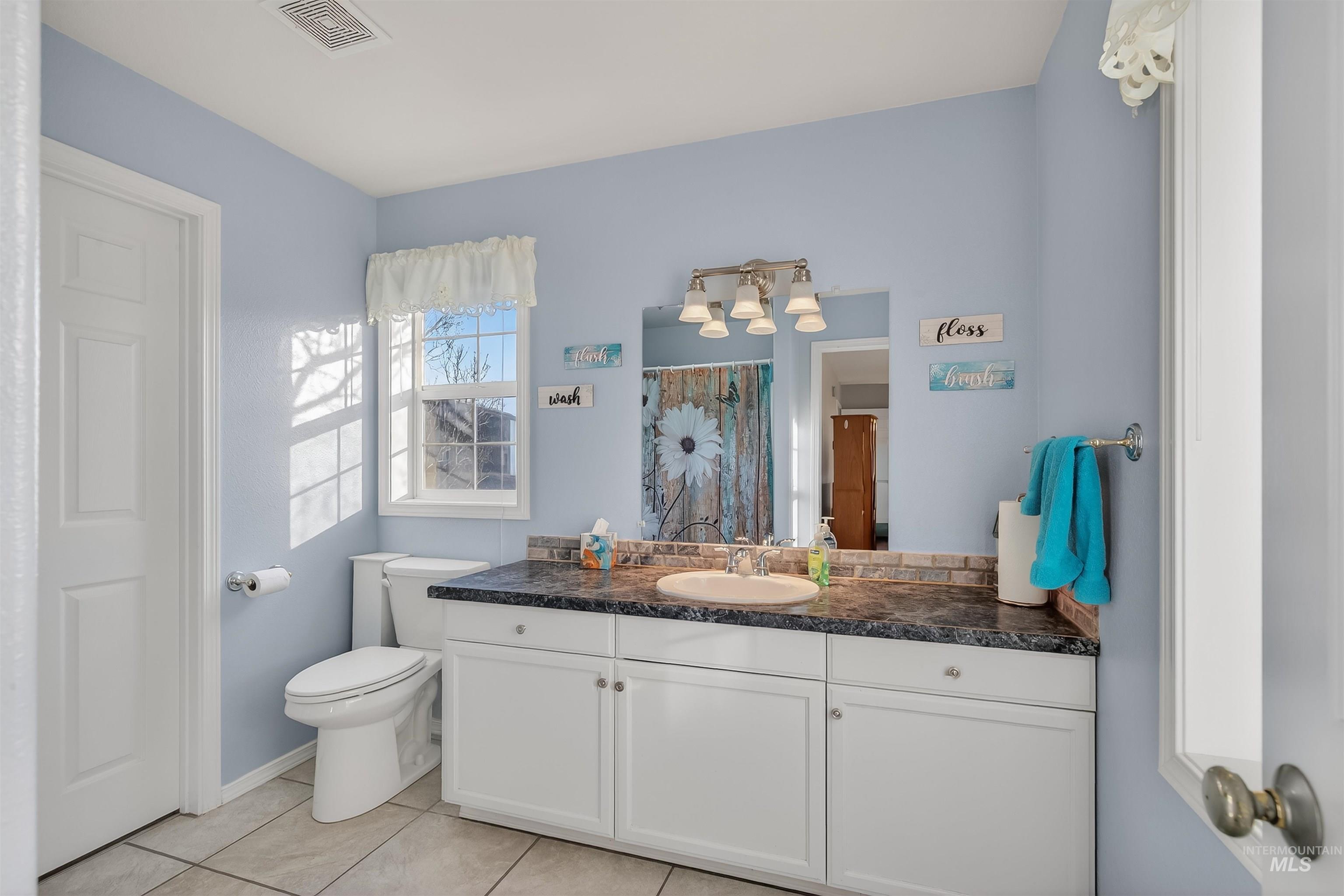 108 Tweedy Lane Kooskia, ID 83539 - Photo 32 of 48 Bathroom featuring vanity, curtained shower, and light tile patterned floors