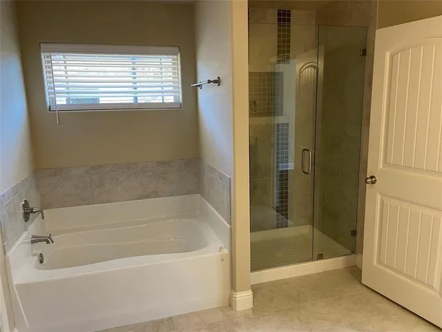 a bathroom with a bathtub and shower