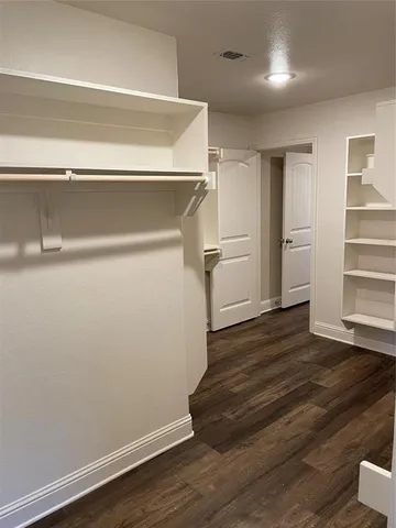 a view of a room with wooden floor