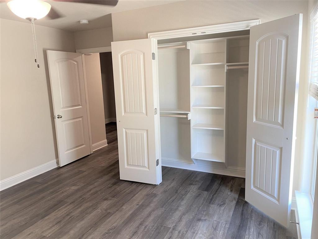 634 Nolan Drive Sherman, TX 75092 - Photo 4 of 18 a view of an empty room with wooden floor and a window