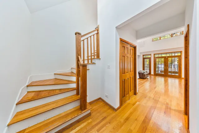 a view of entryway with wooden floor and livingroom view