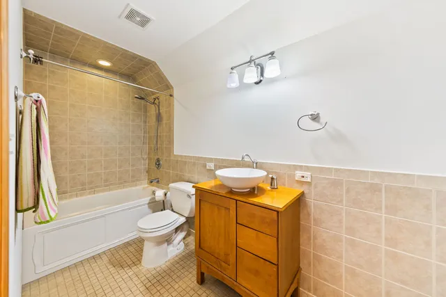 a bathroom with a granite countertop sink toilet a mirror and shower