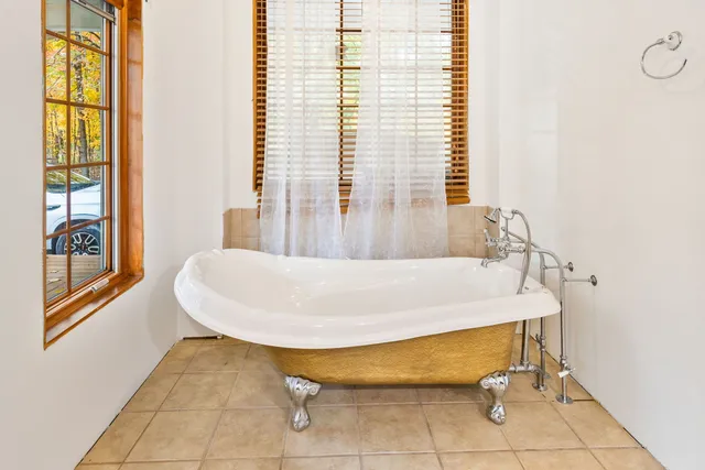 a bath tub sitting in a bathroom next to a window