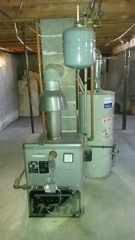 65 Timber Lane Springfield, MA 01119 - Photo 27 of 28 a room with water heater and wooden cabinets