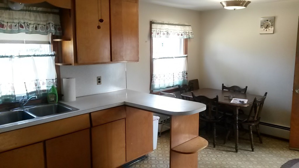 65 Timber Lane Springfield, MA 01119 - Photo 7 of 28 a kitchen with a sink cabinets and a table