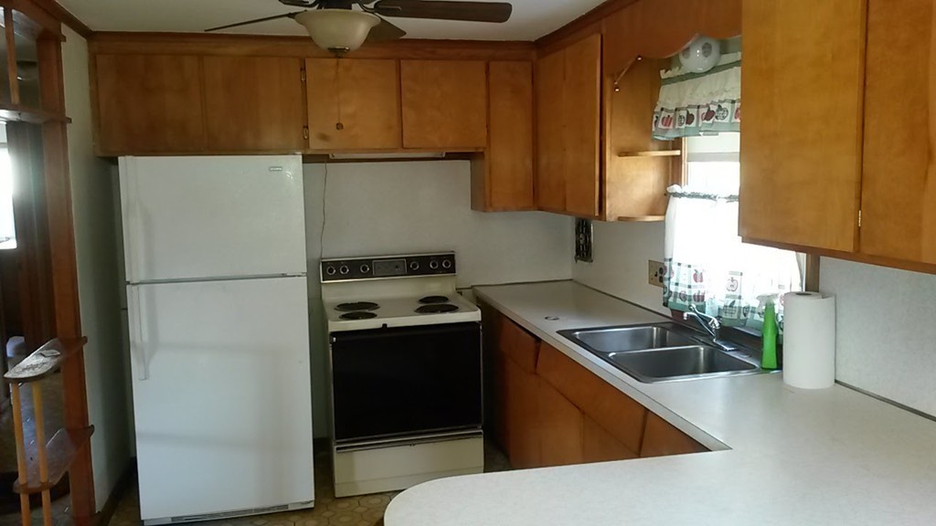65 Timber Lane Springfield, MA 01119 - Photo 9 of 28 a kitchen with stainless steel appliances granite countertop a refrigerator a stove and a sink with wooden floor